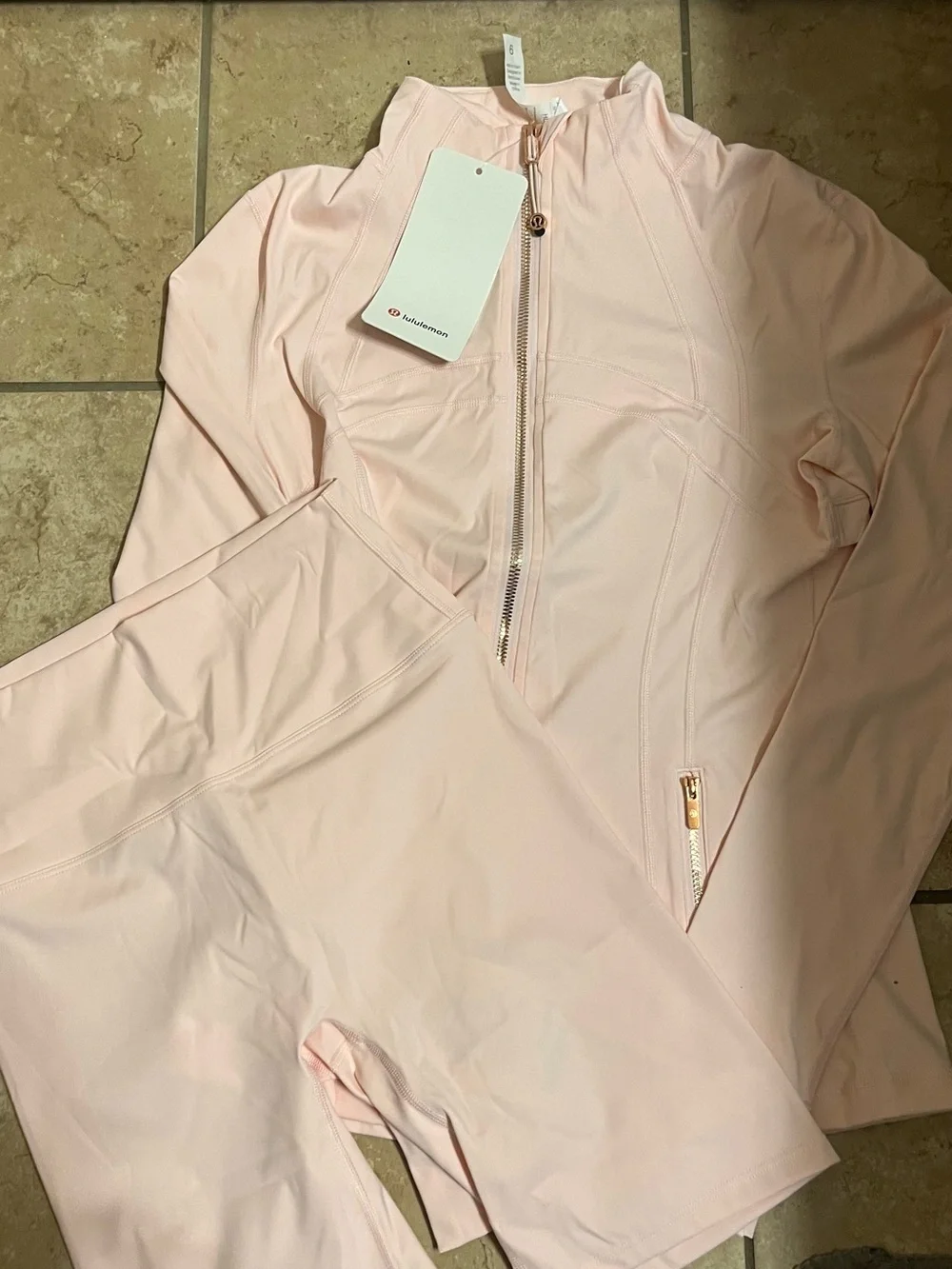 lululemon athletica Women's Pink Full-Zip Jumpsuit with rose gold zipper.